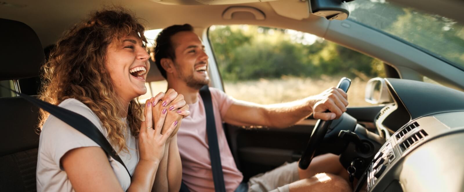 smiling couple in a car