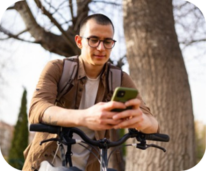 Man using phone riding bike

